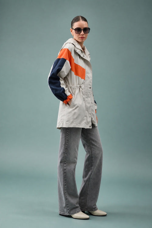 Orange & Navy Block Parka - Side studio full length with sunglasses