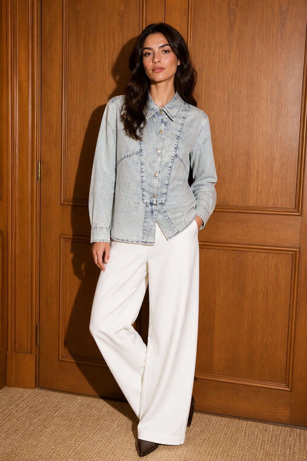 The Amara Denim Shirt - Side pose with white wide-leg trousers